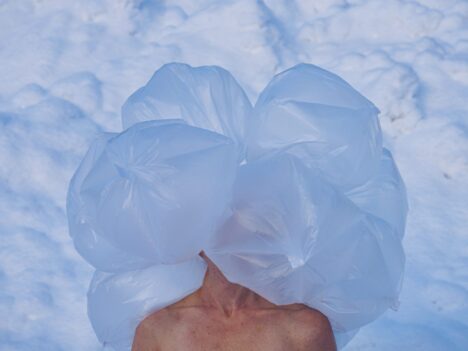 Dancer with thin plastic bags covering her head