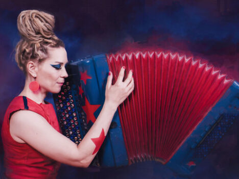 Female artist playing the accordian.