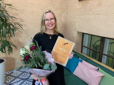 Bild på Mikaela Wickström med diplom och blombukett