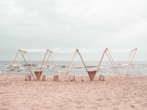 Wooden piece of arcitechture on a sandy beach by the Latvian architect team Marija Katrīna Dambe and Floria Betat.