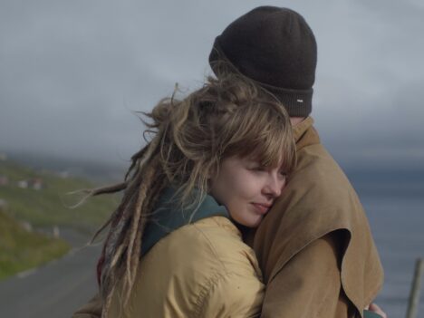 A man and a women are hugging each other outside