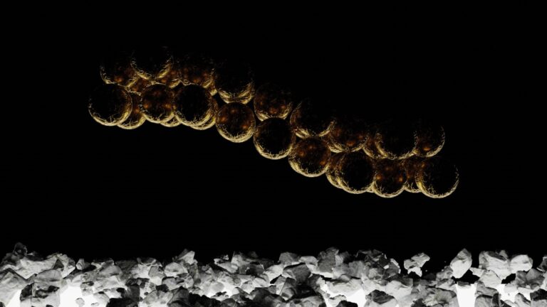 Konstverket 36 atom goldbar av Erwin Laiho. En rad gyllene bollar på svart bakgrund, som svävar ovanför marken täckt med vita stenar.